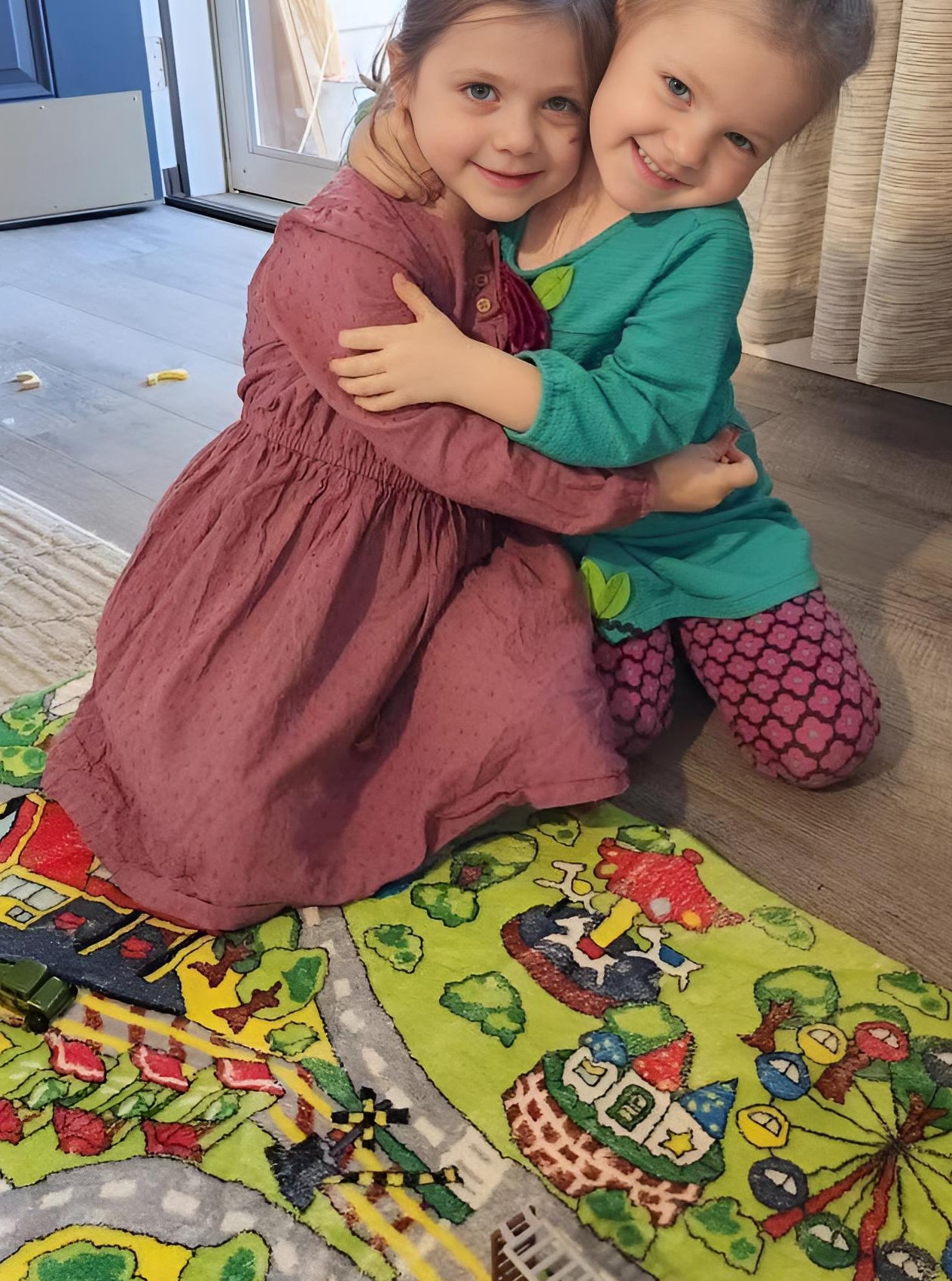 Children drawing while sitting on kids rugs
